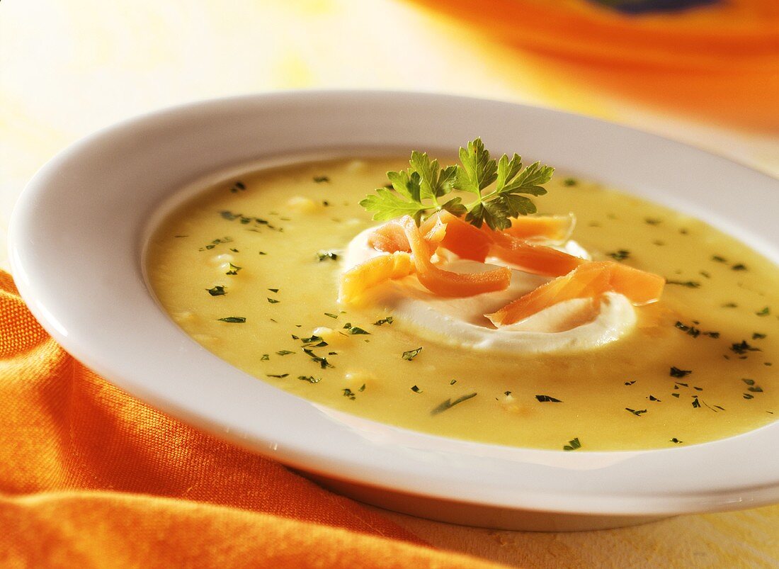 Potato soup with salmon and sour cream on plate