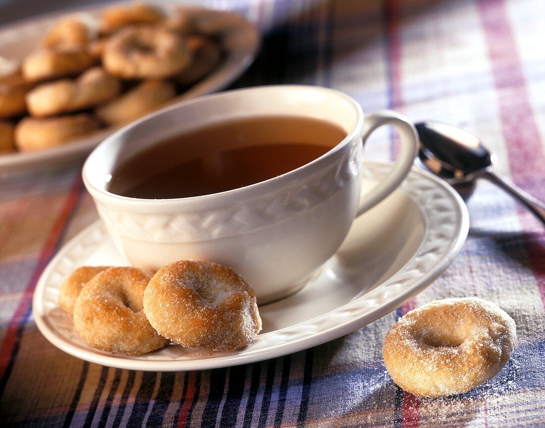 Cup of tea with cakes (small doughnut rings)