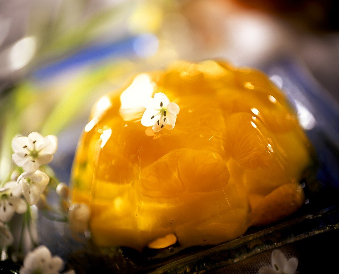 Jelly with mandarin oranges and pineapple; white flowers