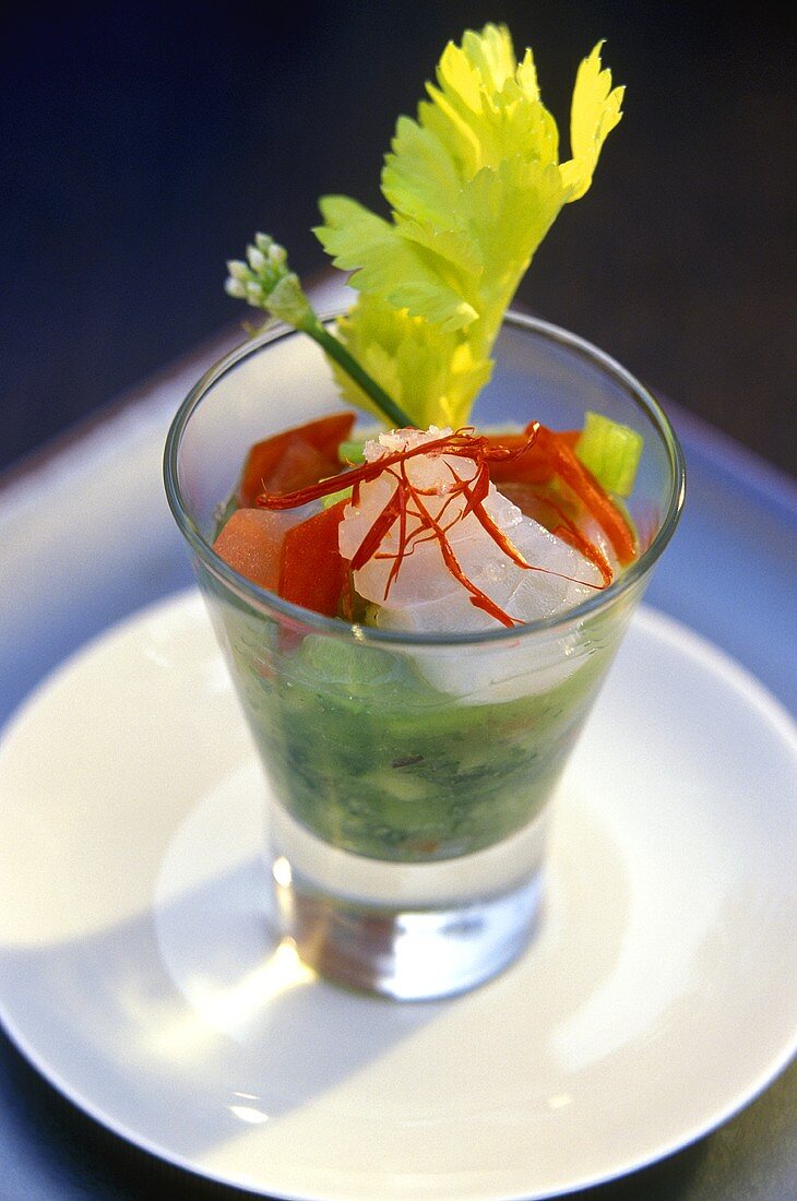 Gazpacho with fish, herbs and celery in glass