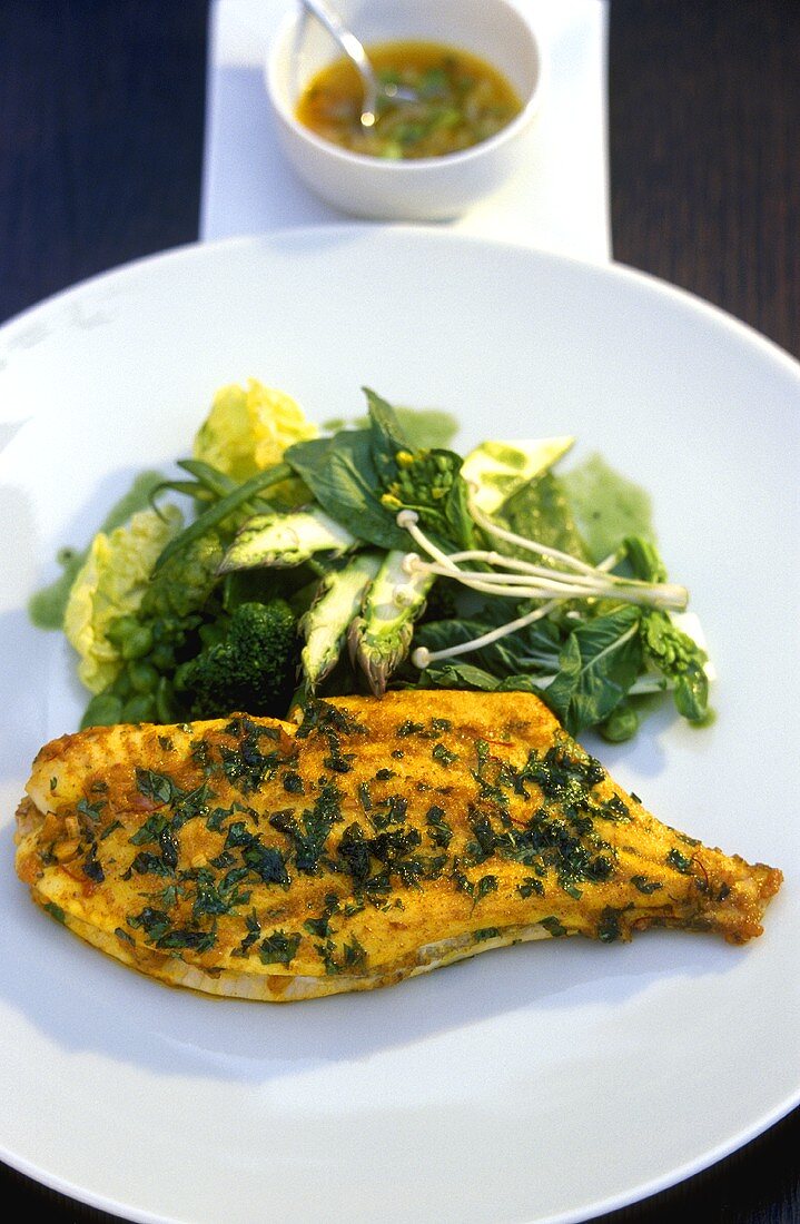 Fried plaice with herbs and green vegetables