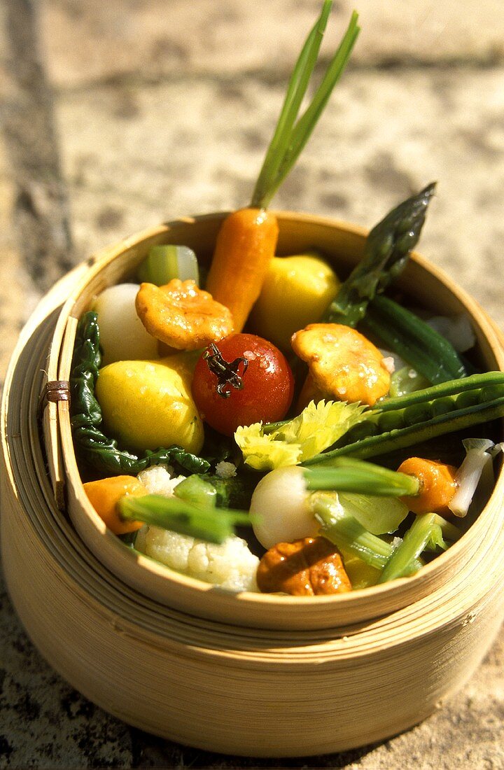 Steamed vegetables and mushrooms in bamboo steamer