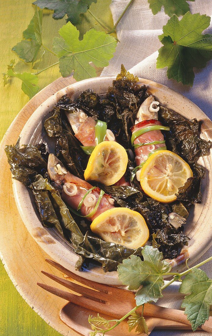 Sardines in vine leaves with ham and lemon