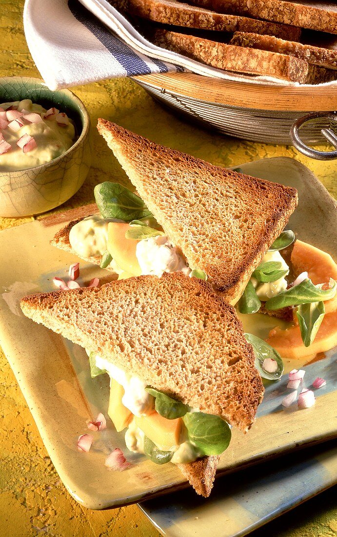 Avocado sandwiches with papaya and corn salad