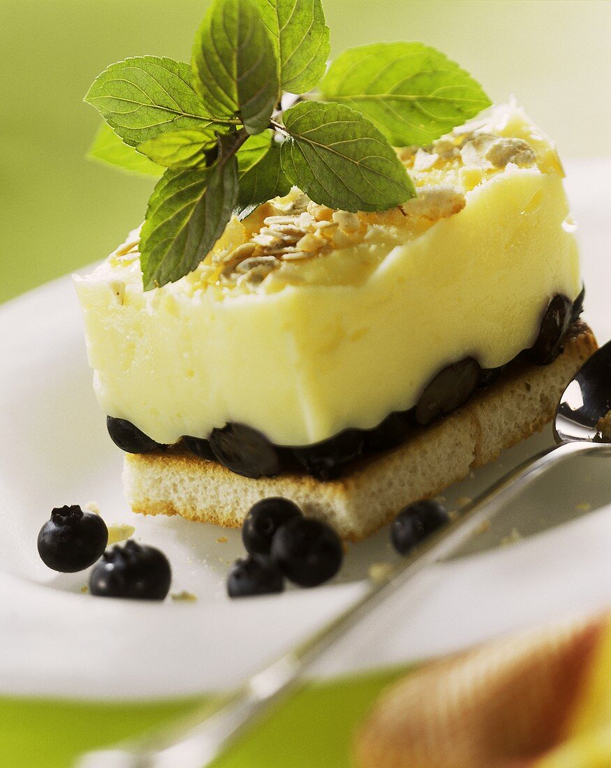 Zwieback (rusk) with muesli mousse, blueberries & sprig of mint