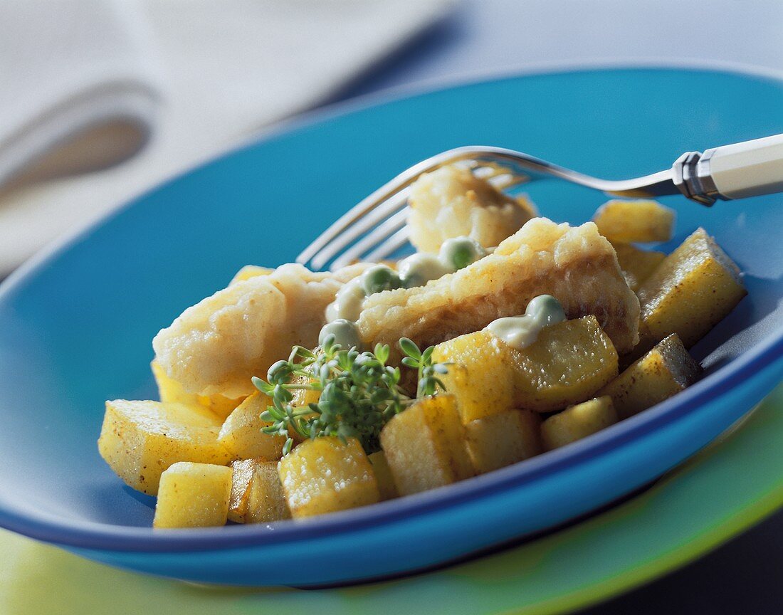 Pan-cooked fish and potato dish with peas and cress