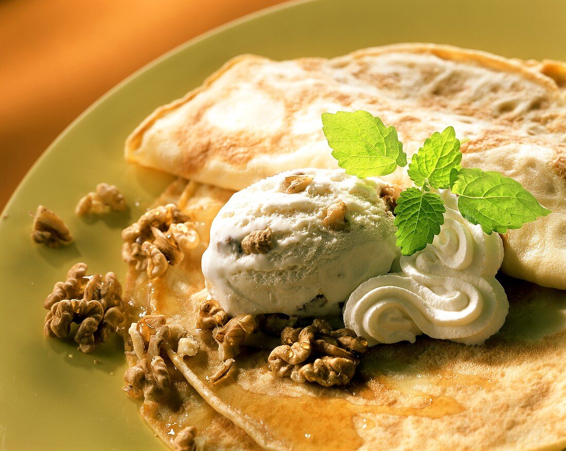 Crepes with walnut ice cream, maple syrup and cream