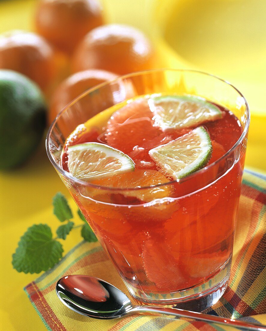 Mandarin and grapefruit punch with lime wedges