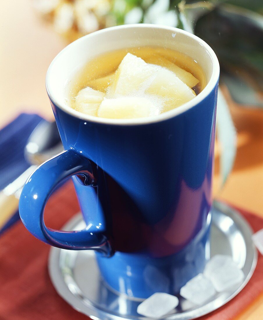 Punch with pineapple in blue cup