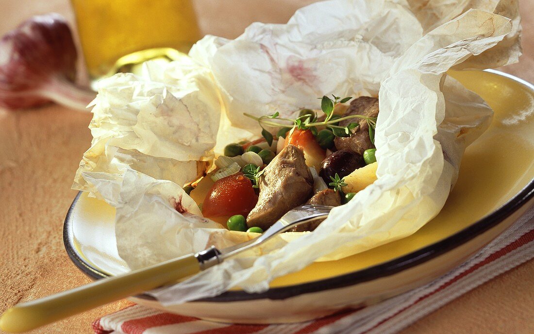 Lamb with vegetables and thyme in baking paper