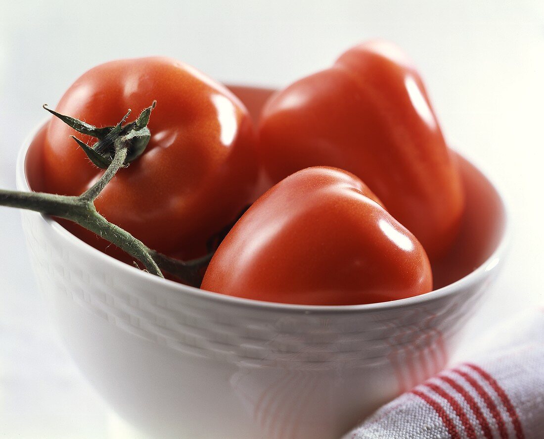 Tomatoes on the vine in white bowl