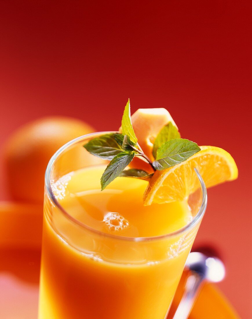 Orange juice in glass with fresh mint