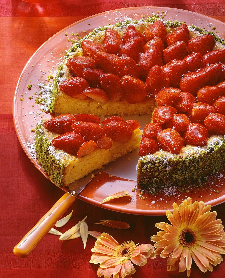 Carrot cake with strawberries, a piece cut