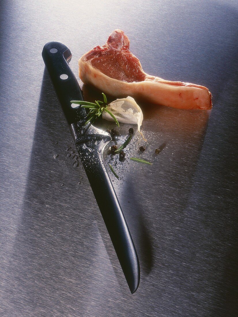 Boning knife beside pork chop