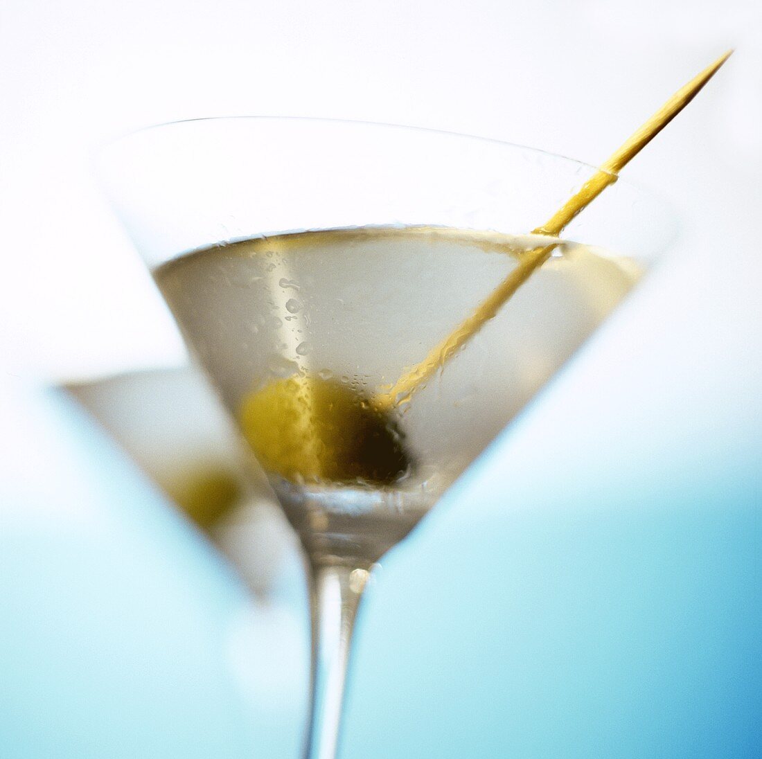 Martini with green olive and toothpick