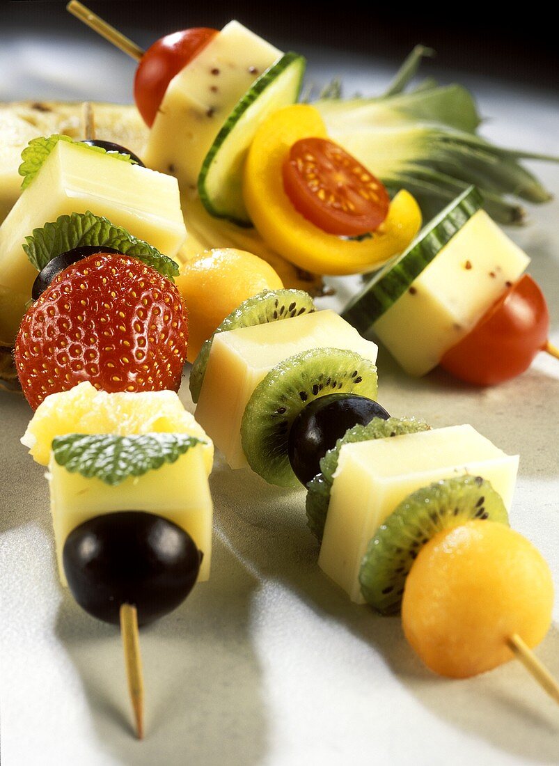 Colourful cheese kebabs with fruit and vegetables