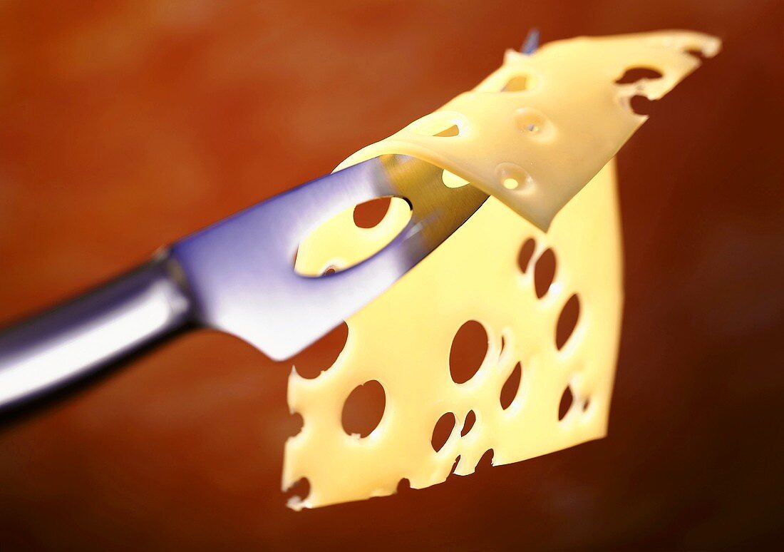 Slice of Emmental cheese on cheese knife