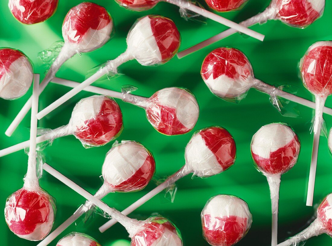 Lots of red and white lollipops in cellophane paper