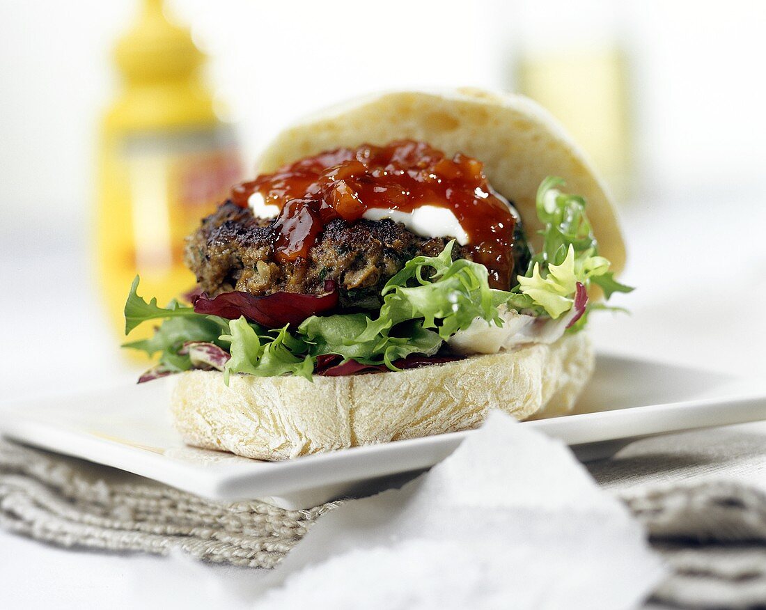 Hamburger with ketchup in ciabatta roll