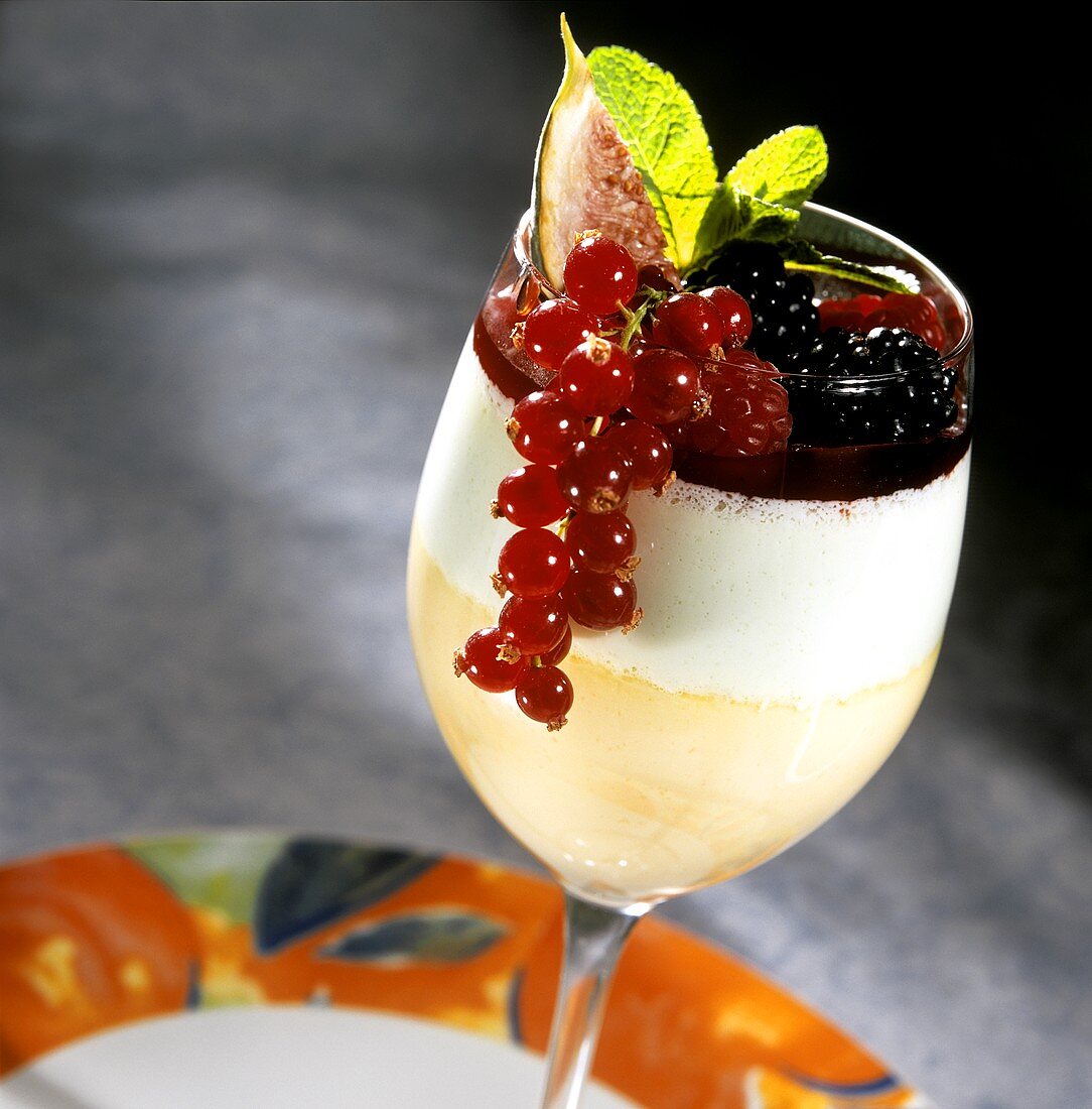 Fruit mousse with cream and red berries