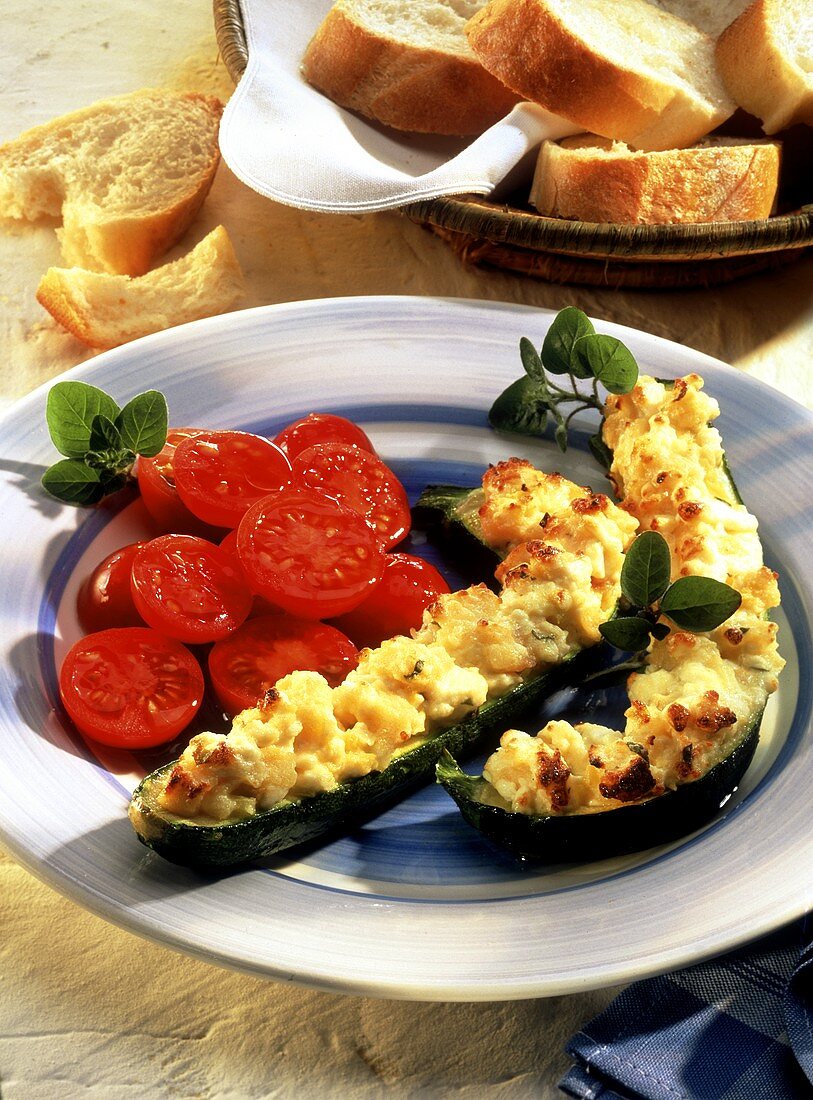 Courgettes with sheep's cheese and tomato salad; baguette