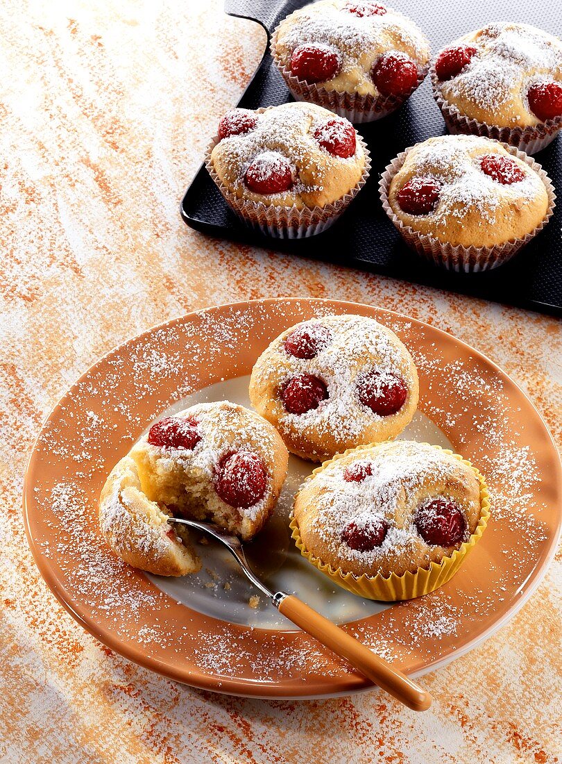 Cherry and marzipan buns with icing sugar
