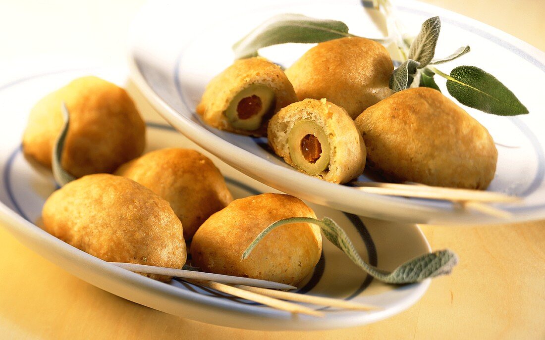 Crispy olive balls with sprigs of sage