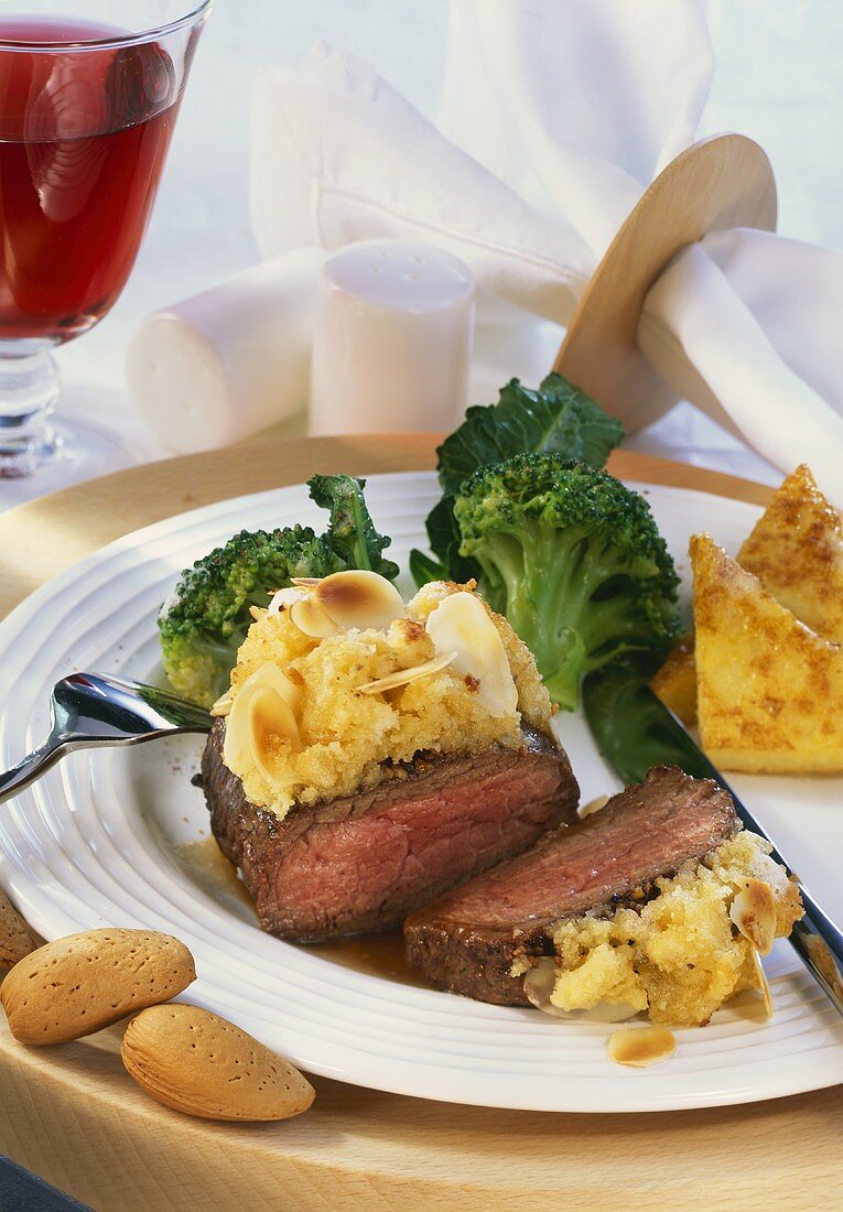 Venison loin with almond crust, broccoli and polenta