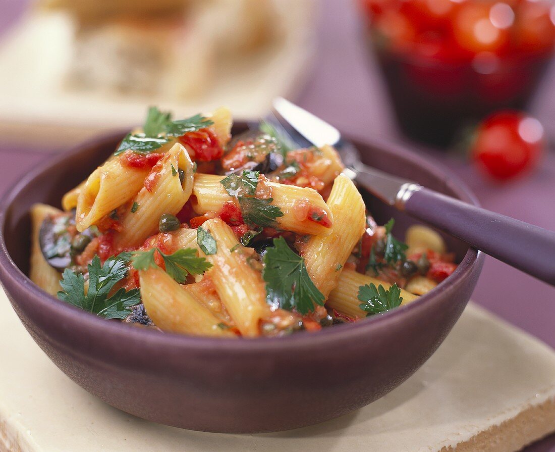 Penne with tomato and caper sauce and parsley