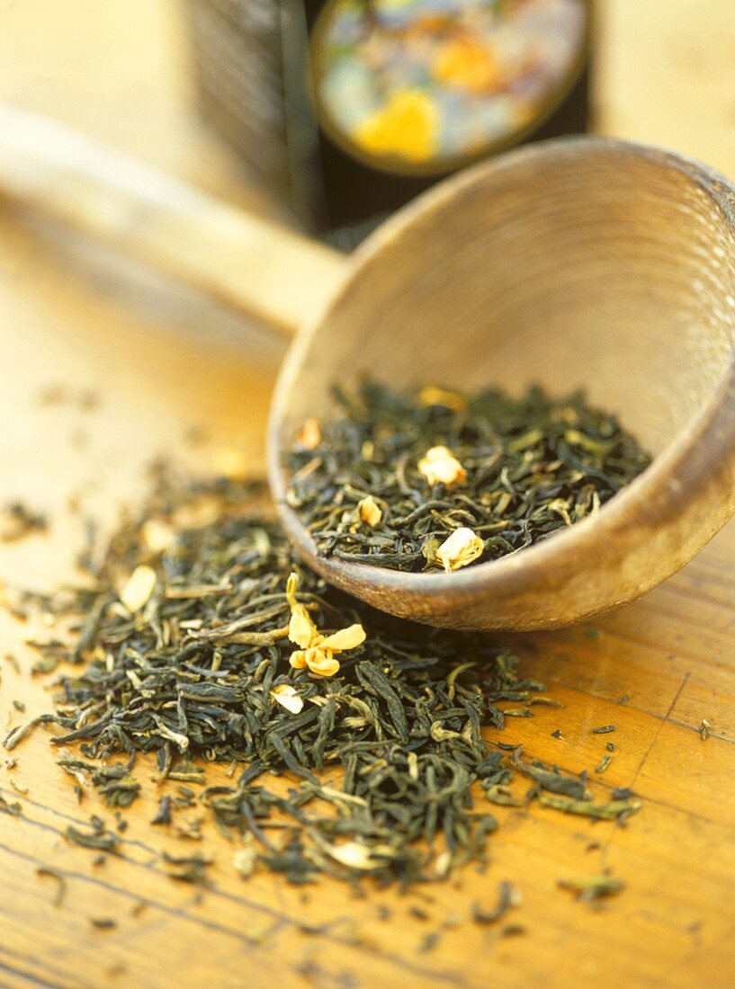 Green tea on wooden background and in bowl