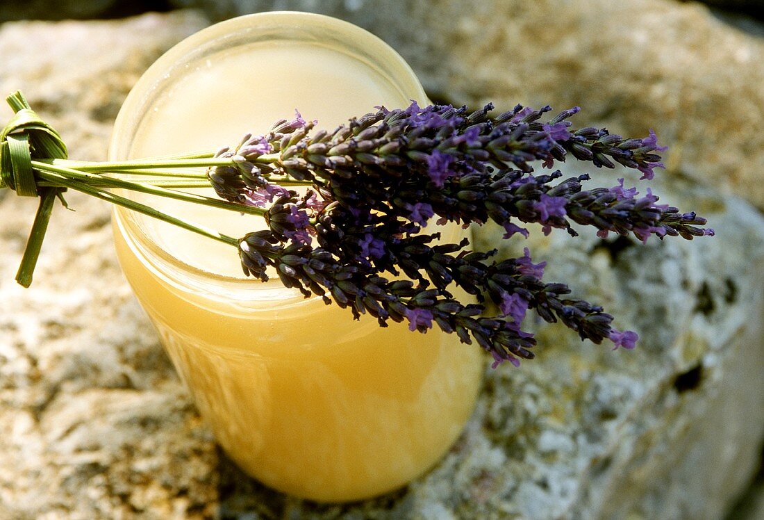 Lavender honey in jar, lavender flowers on top