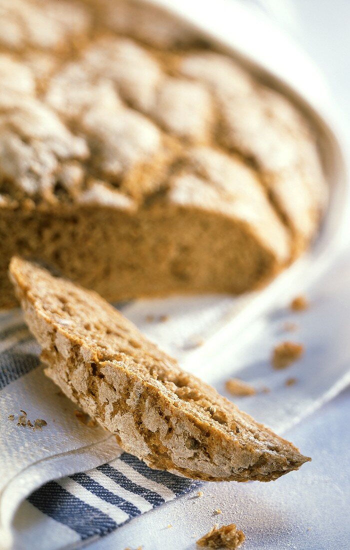 Brown coriander bread, a slice cut