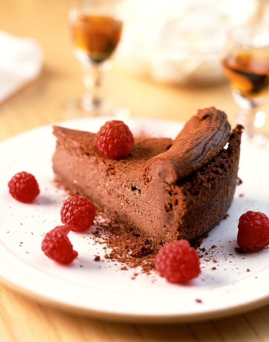 Piece of chocolate coconut cake with fresh raspberries