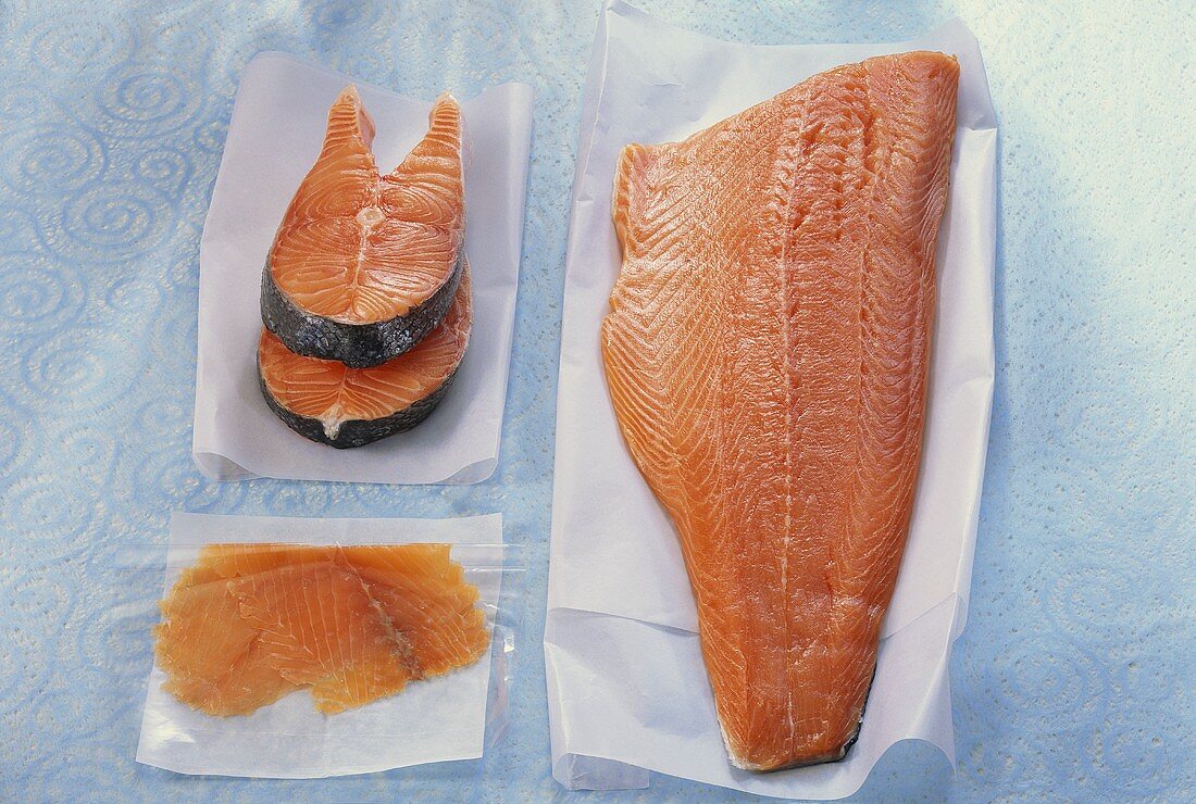 Salmon cutlet, smoked salmon & salmon fillet on waxed paper