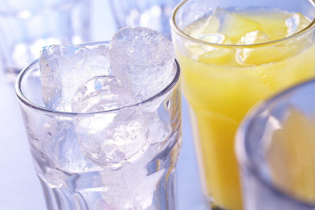 Ice cubes in glass; orange juice