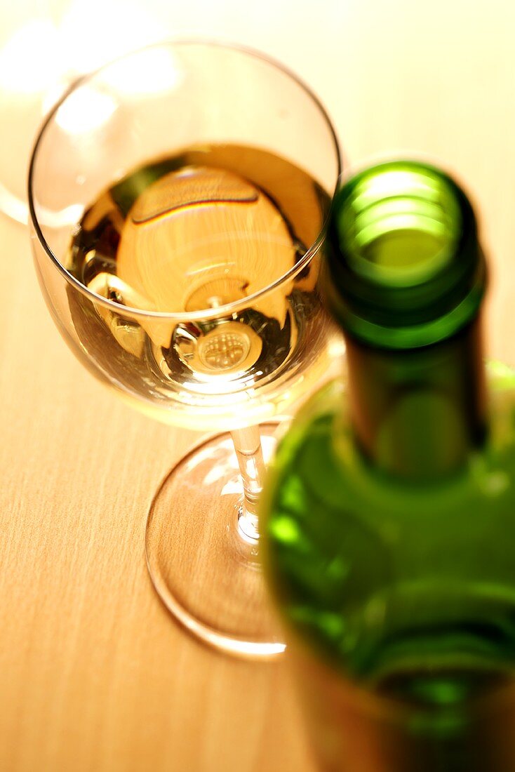 White wine glass and wine bottle