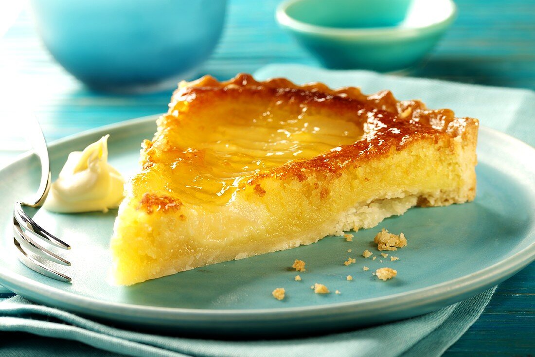 Piece of pear tart on blue plate