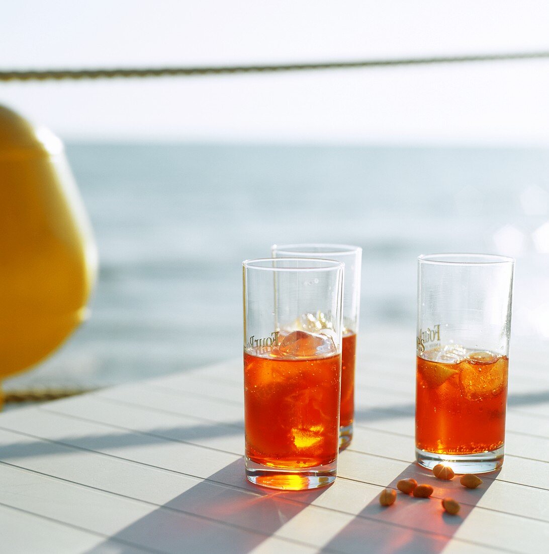 Three glasses of Aperol on beach