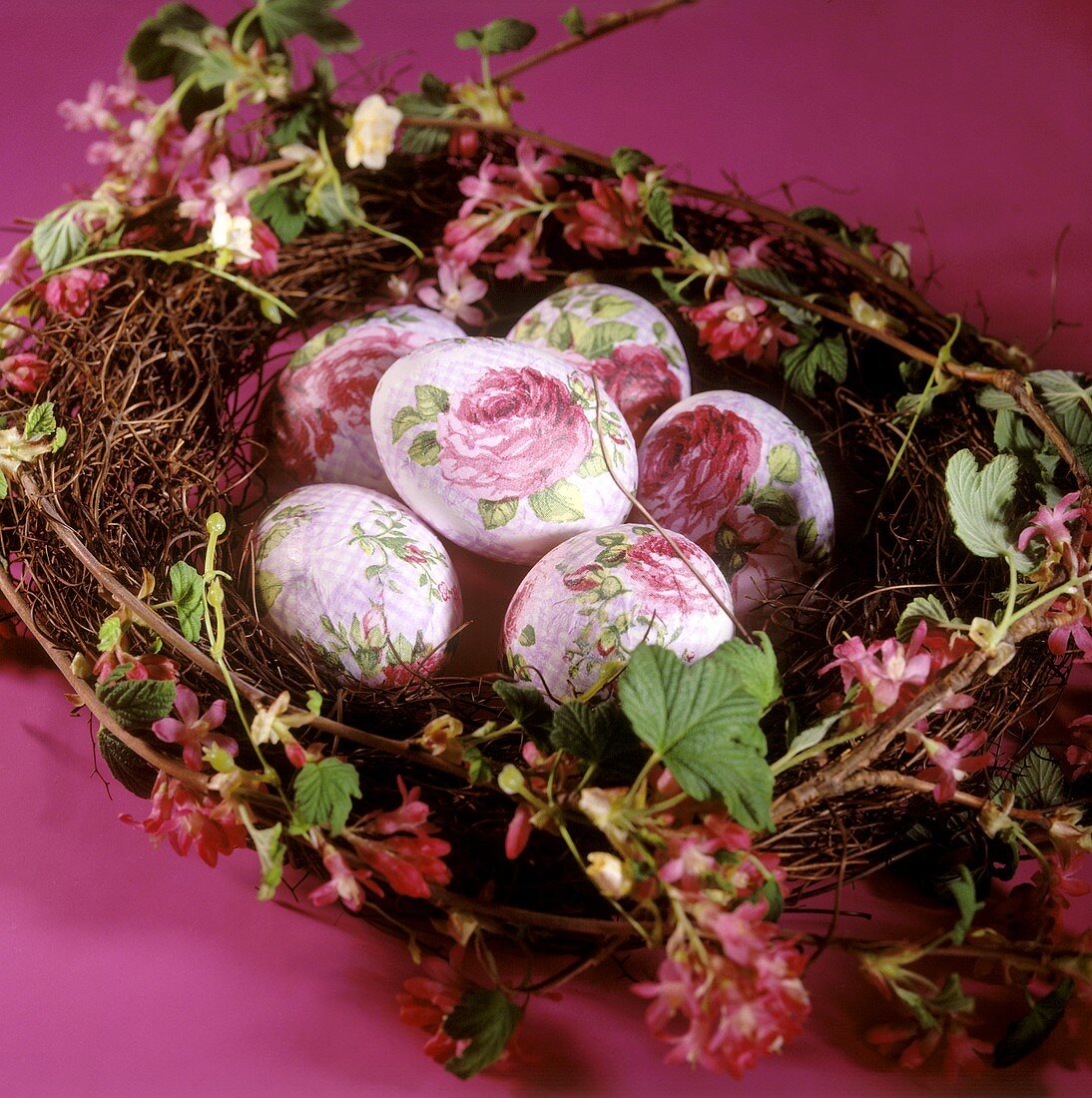 Easter eggs with rose decoration in spring wreath