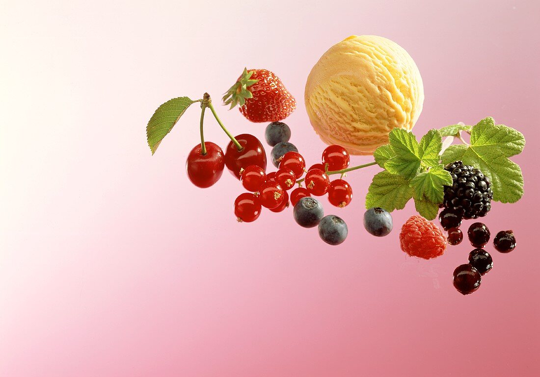 Scoop of vanilla ice cream, fresh berries and cherries