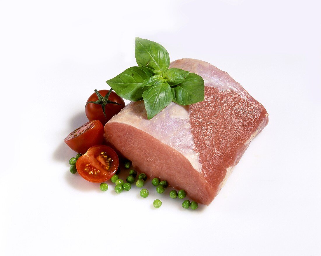 Lean raw pork with basil, peas and tomatoes