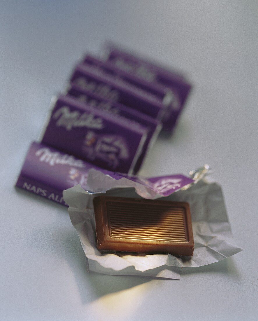 Small chocolate bars (Milka Naps) wrapped & unwrapped