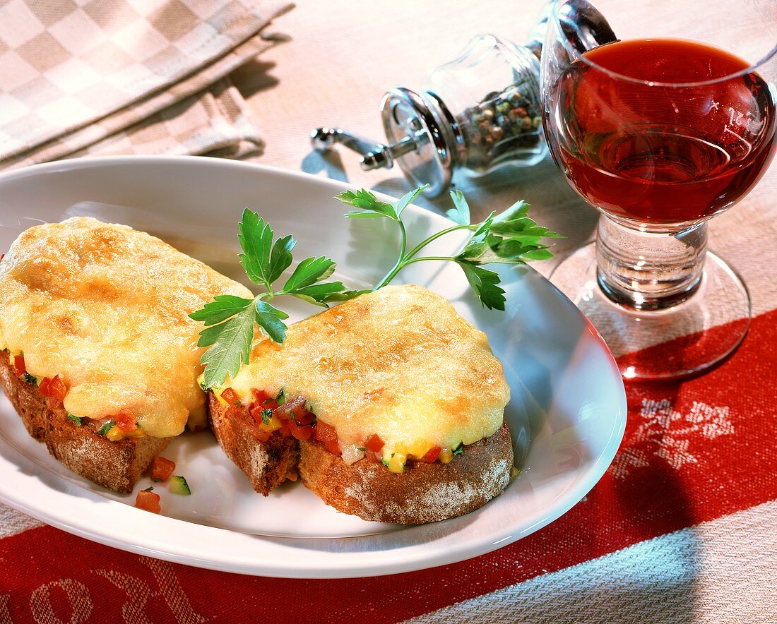 Toasted cheese on rye bread; red wine glass