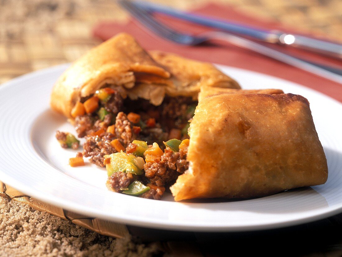 Lamb chimichangas with peppers, a piece cut