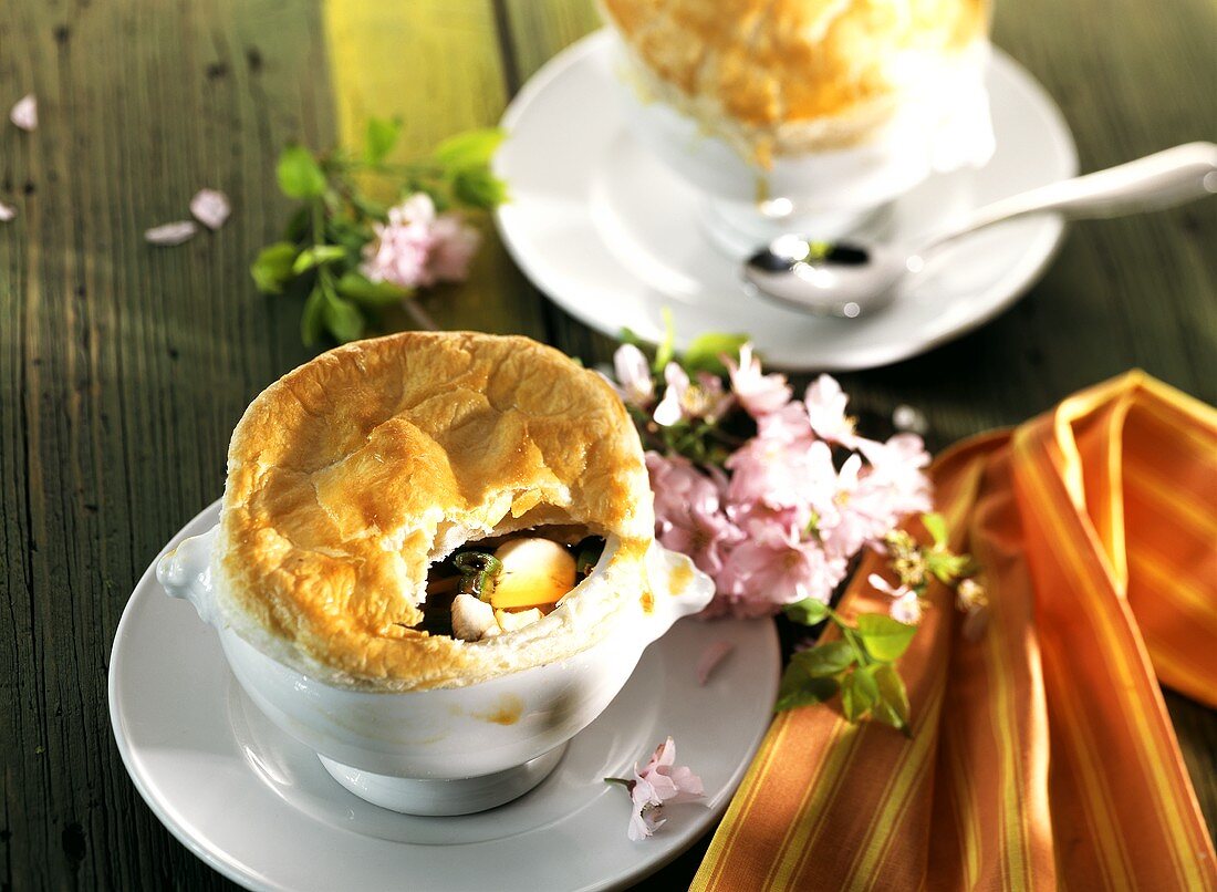 Spring soup under puff pastry crust