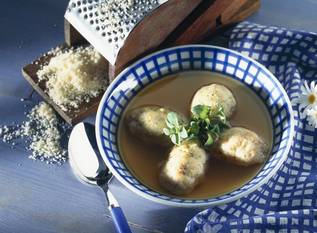 Swiss cheese balls in vegetable bouillon with marjoram