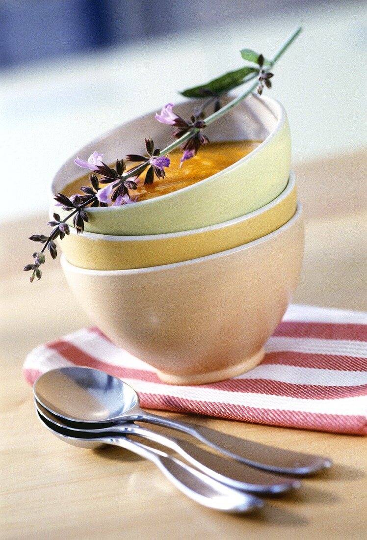 Creamed carrot soup with fresh herb sprig in bowl