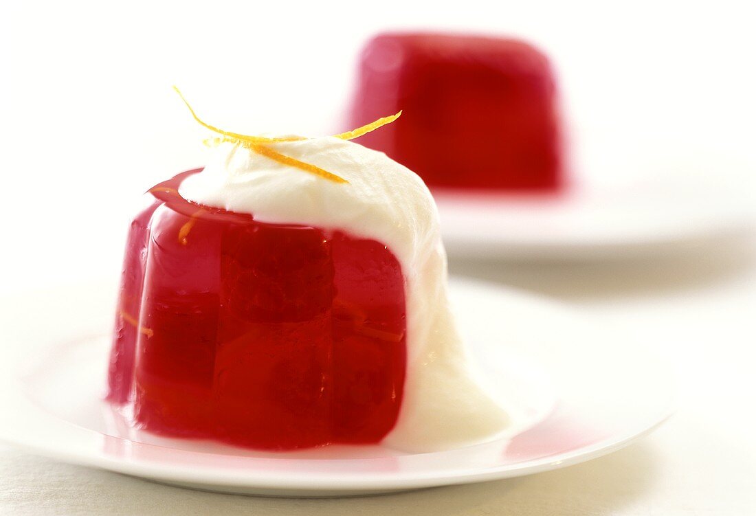 Red jelly with raspberries and whipped cream