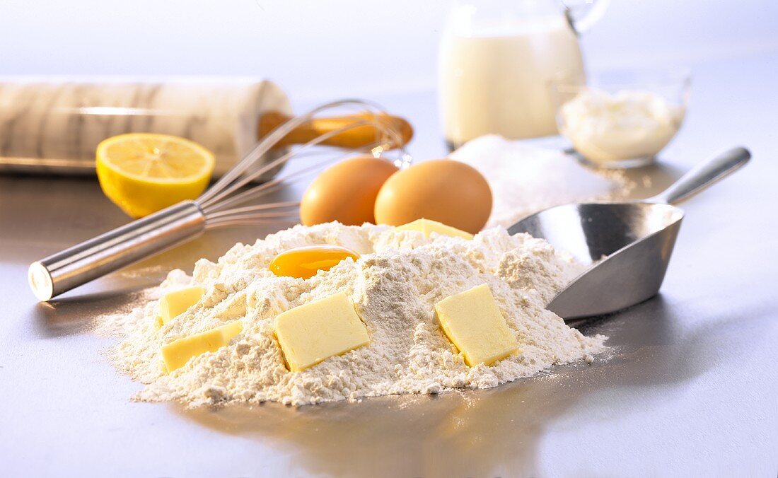 Baking still life with flour, eggs, butter etc & utensils