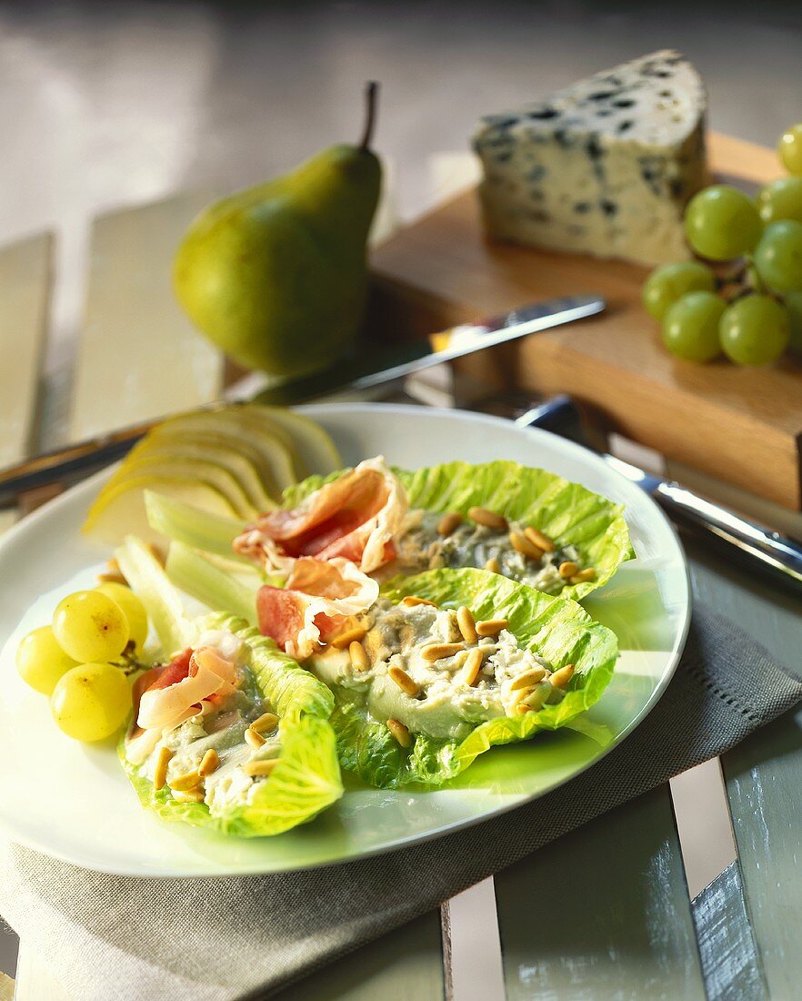 Romaine lettuce with raw ham, Roquefort, fruit and pine nuts